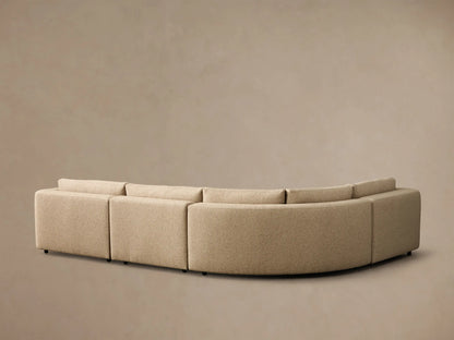 Close-up of the beige textured fabric on the armrest and back cushion of the Stiles Four-Piece Sectional.