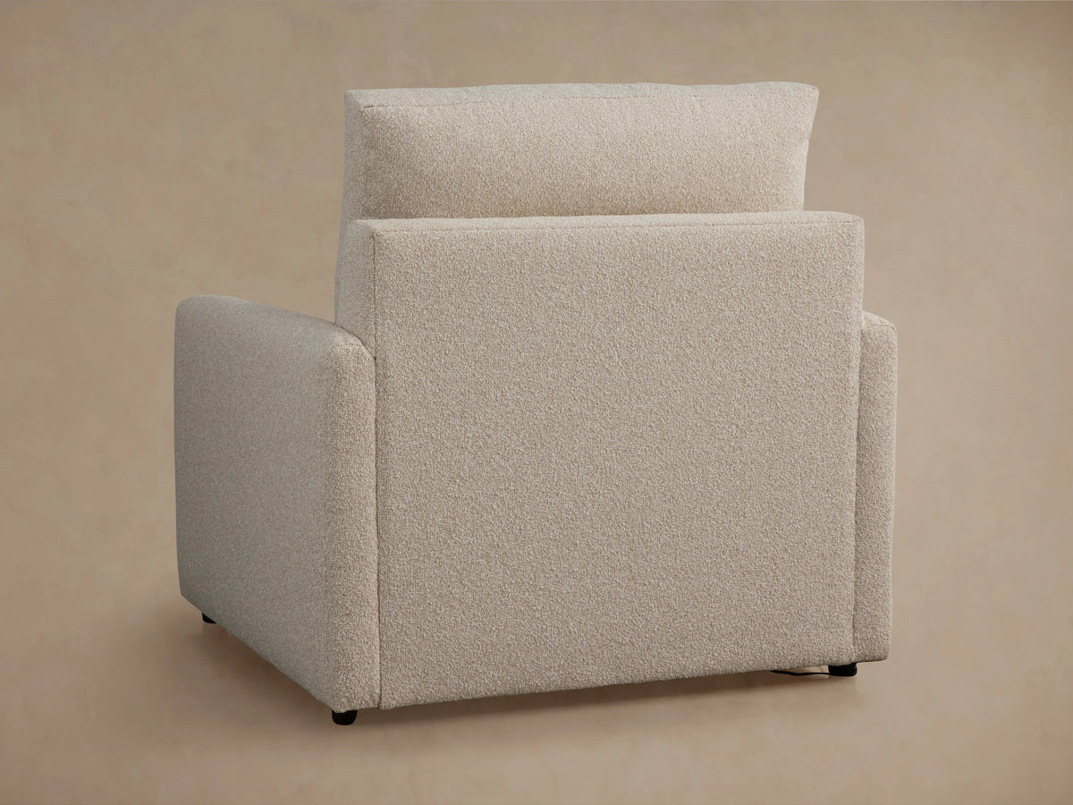 Kipton Motion Recliner in beige fabric, side view, with footrest extended. Slim arm design, set against a neutral background.