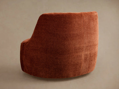 Sonny Swivel Chair: Angled close-up of the chair in burnt orange ribbed corduroy fabric, showing its curved backrest and seat.