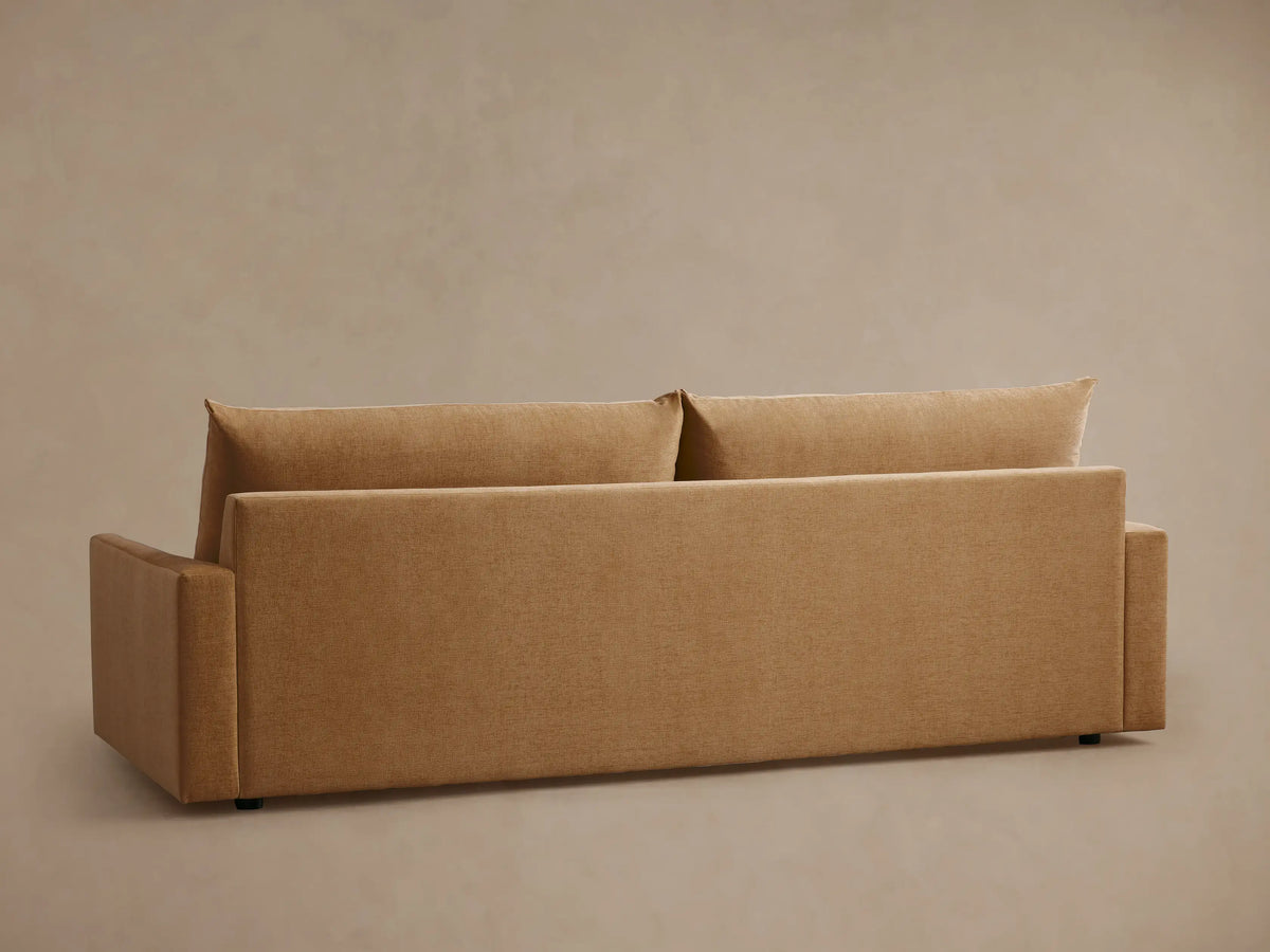 Calistoga Sofa in warm brown fabric showing smooth seat and back cushions, with sleek armrests and subtle texture.