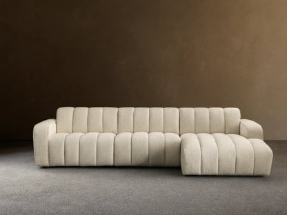 Front view of cream channel-tufted Bracco Three-Piece Chaise Sectional with a left-side chaise on a wooden floor.