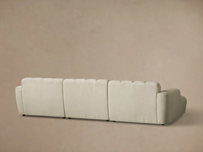 Close-up of the light beige textured fabric on the Bracco Three-Piece Chaise Sectional, highlighting the channel tufting.