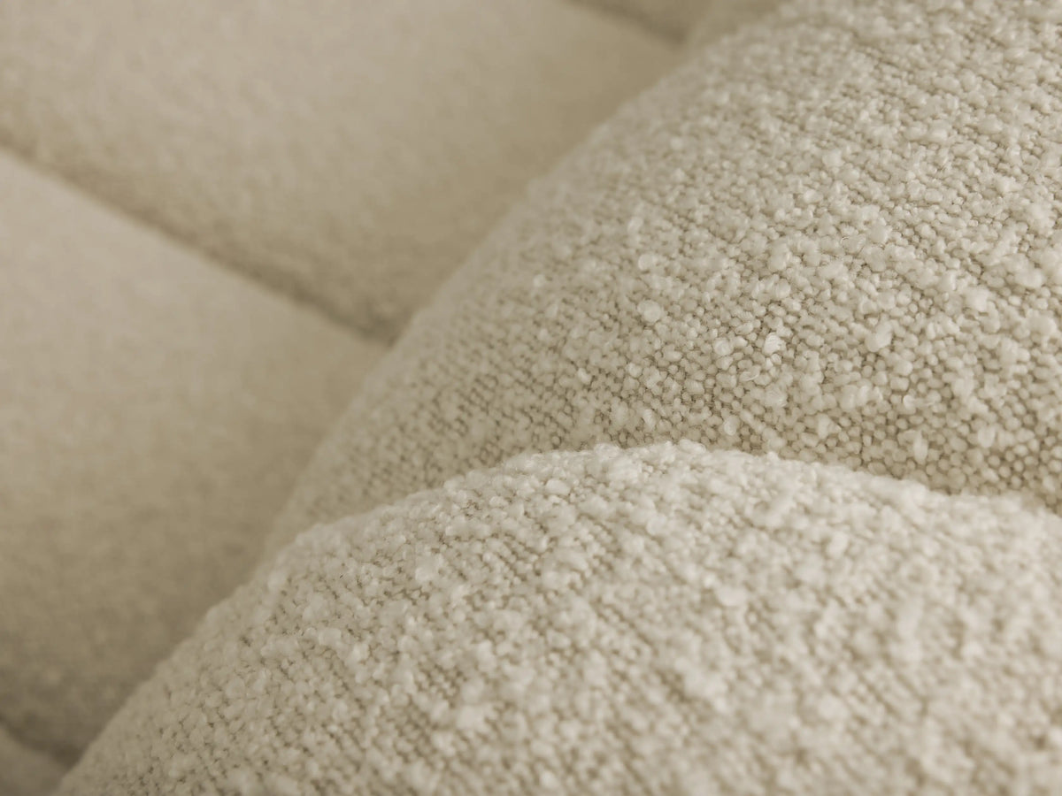 Close-up of the light beige bouclé fabric on the Bracco Three-Piece Chaise Sectional.