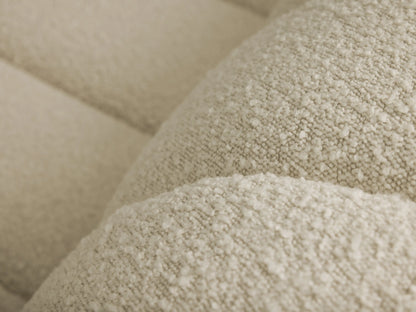 Close-up of the light beige bouclé fabric on the Bracco Three-Piece Chaise Sectional.