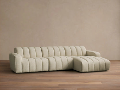 Front view of a cream Bracco Three-Piece Chaise Sectional with vertical channel tufting, textured fabric, and a right-facing chaise.