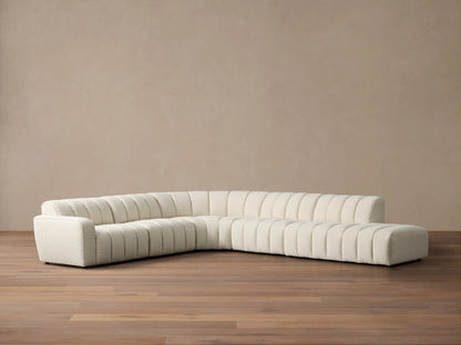 Front view of the cream Bracco Five-Piece Bumper Sectional, featuring channel tufting and a right-side bumper.