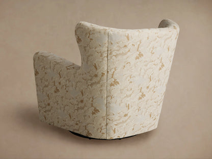 Close-up, angled view of Sasha Swivel Chair's curved arm and back, upholstered in cream textured fabric with tan abstract pattern.