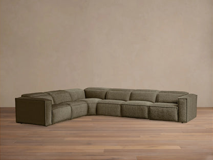 Coburn Six-Piece Motion Sectional, L-shaped, in deep olive textured fabric against a light wall on a wood floor.