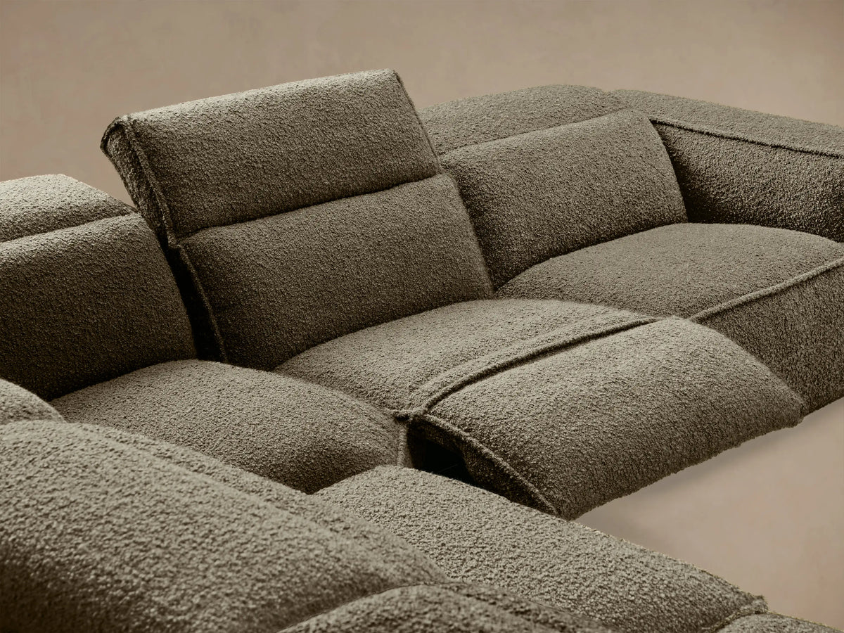 Dark olive green Coburn Six-Piece Motion Sectional, L-shaped, textured fabric, on wooden floor against a beige wall.