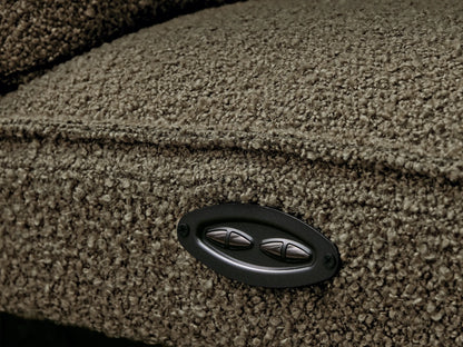 Close-up of brown, plush Coburn Six-Piece Motion Sectional. One backrest is reclined, and a footrest is partially elevated.
