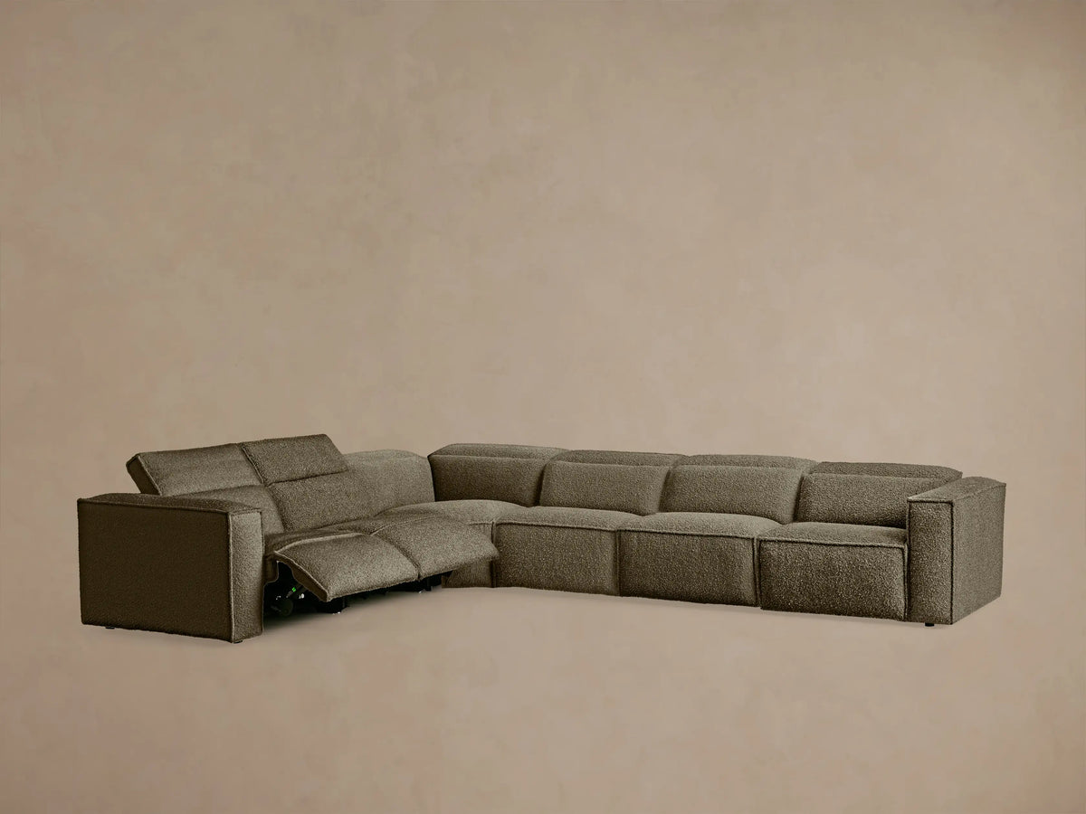 Close-up of Coburn Motion Sectional's beige bouclé Crypton fabric, showing black oval two-button control panel.