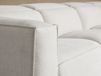 Close-up of the beige textured fabric seat cushion and backrest of the Coburn Five-Piece Motion Corner Sectional.