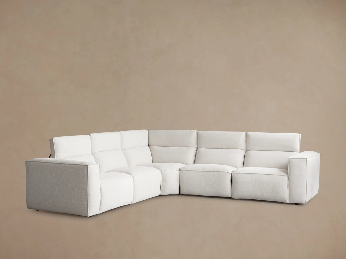 Coburn Five-Piece Motion Corner Sectional in light neutral fabric, viewed from the back left, against a plain beige background.