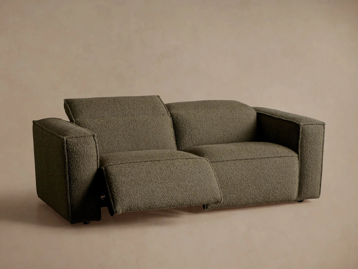 Back and right side of a Coburn Two-Piece Motion Sofa in dark olive green textured fabric, featuring two structured backrests.