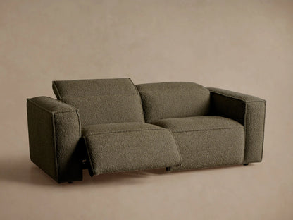 Back and right side of a Coburn Two-Piece Motion Sofa in dark olive green textured fabric, featuring two structured backrests.