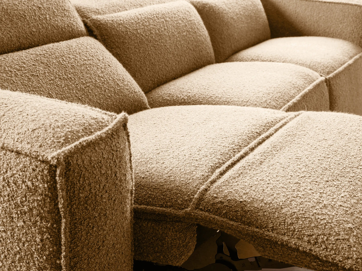 Coburn Three-Piece Motion Sofa: light beige textured fabric, blocky arms, three distinct seat sections, on wood floor.