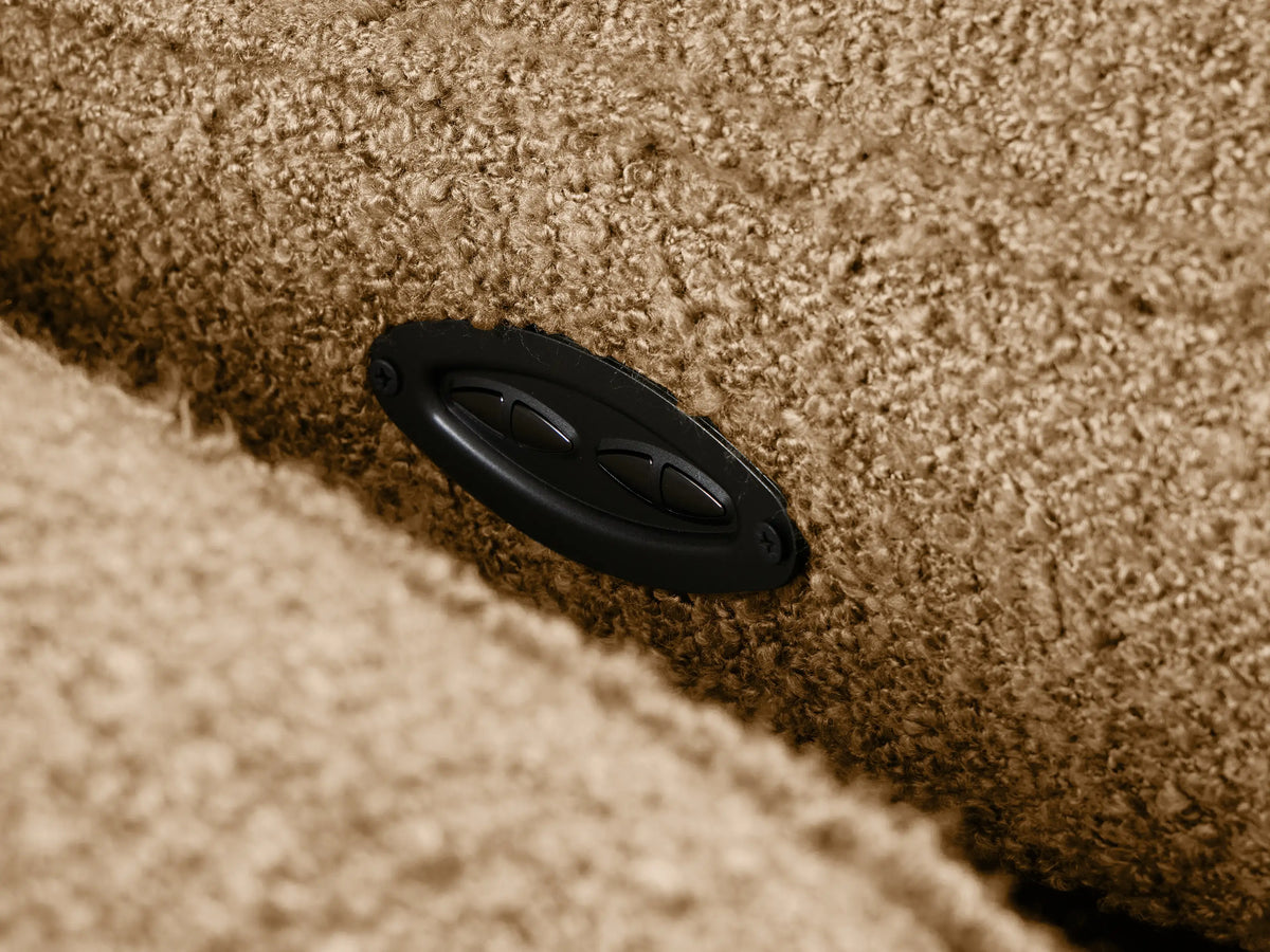 Close-up of Coburn Motion Sofa in textured beige fabric, showing plush seat, back, and elevated footrest.