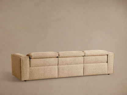 Close-up of Coburn Motion Sofa's textured tan fabric with an embedded black oval two-button reclining control panel.