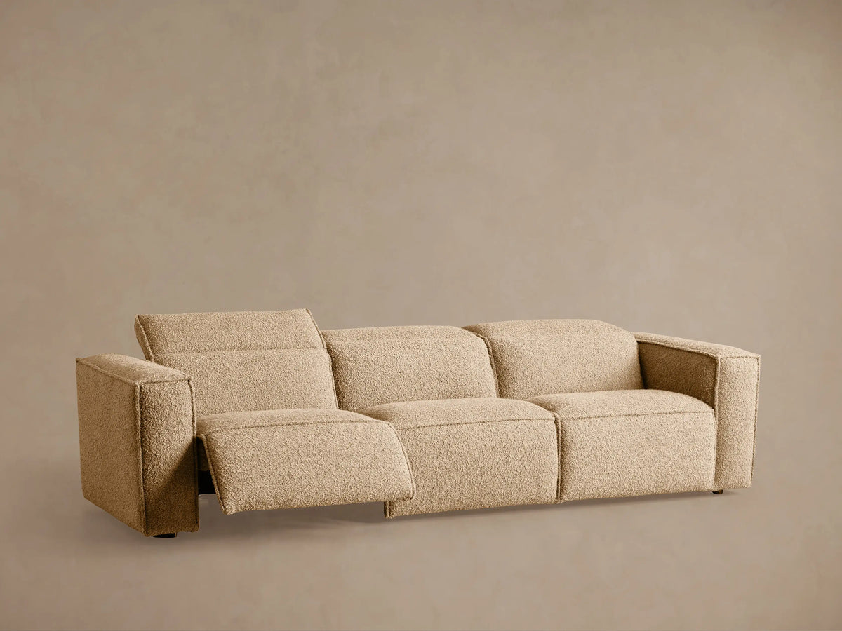 Coburn Three-Piece Motion Sofa, light beige textured fabric, seen from the back-right with three sections.