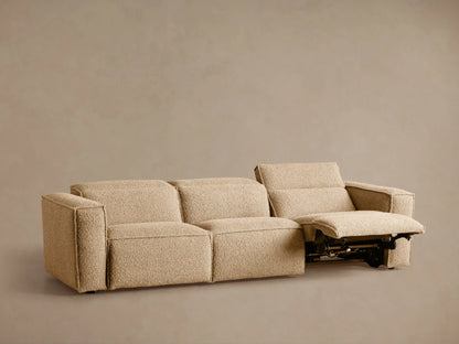 Coburn Three-Piece Motion Sofa, light beige textured fabric. Left section reclined with elevated footrest & tilted backrest.