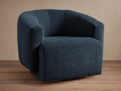 Dark blue Hamlin Swivel Chair on wooden floor, featuring a rounded backrest and armrests. Chair has a solid steel swivel base.