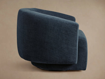 Dark blue Hamlin Swivel Chair with smooth upholstery, featuring a curved backrest and armrests, set against a neutral background.