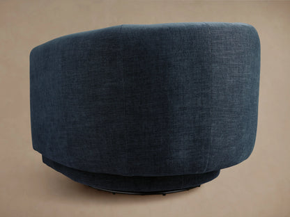 Dark blue Hamlin Swivel Chair with a smooth fabric finish, featuring a curved backrest and seat, shown in a side view on a neutral background.