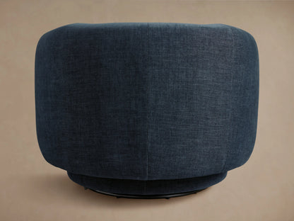 A dark blue Hamlin Swivel Chair with a rounded backrest and subtle texture, shown from the side on a neutral background.