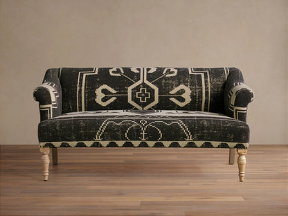 Anya Settee, black and cream fabric with distressed geometric tribal pattern, rolled arms, light turned wood legs.