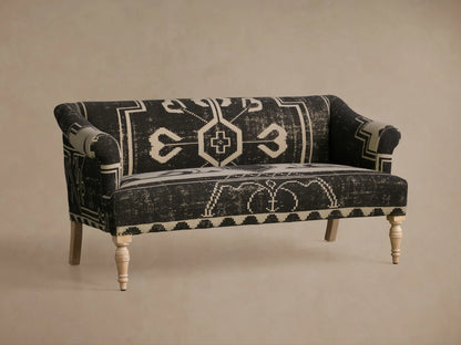 Anya Settee, black and cream fabric with distressed geometric tribal pattern, rolled arms, light turned wood legs.