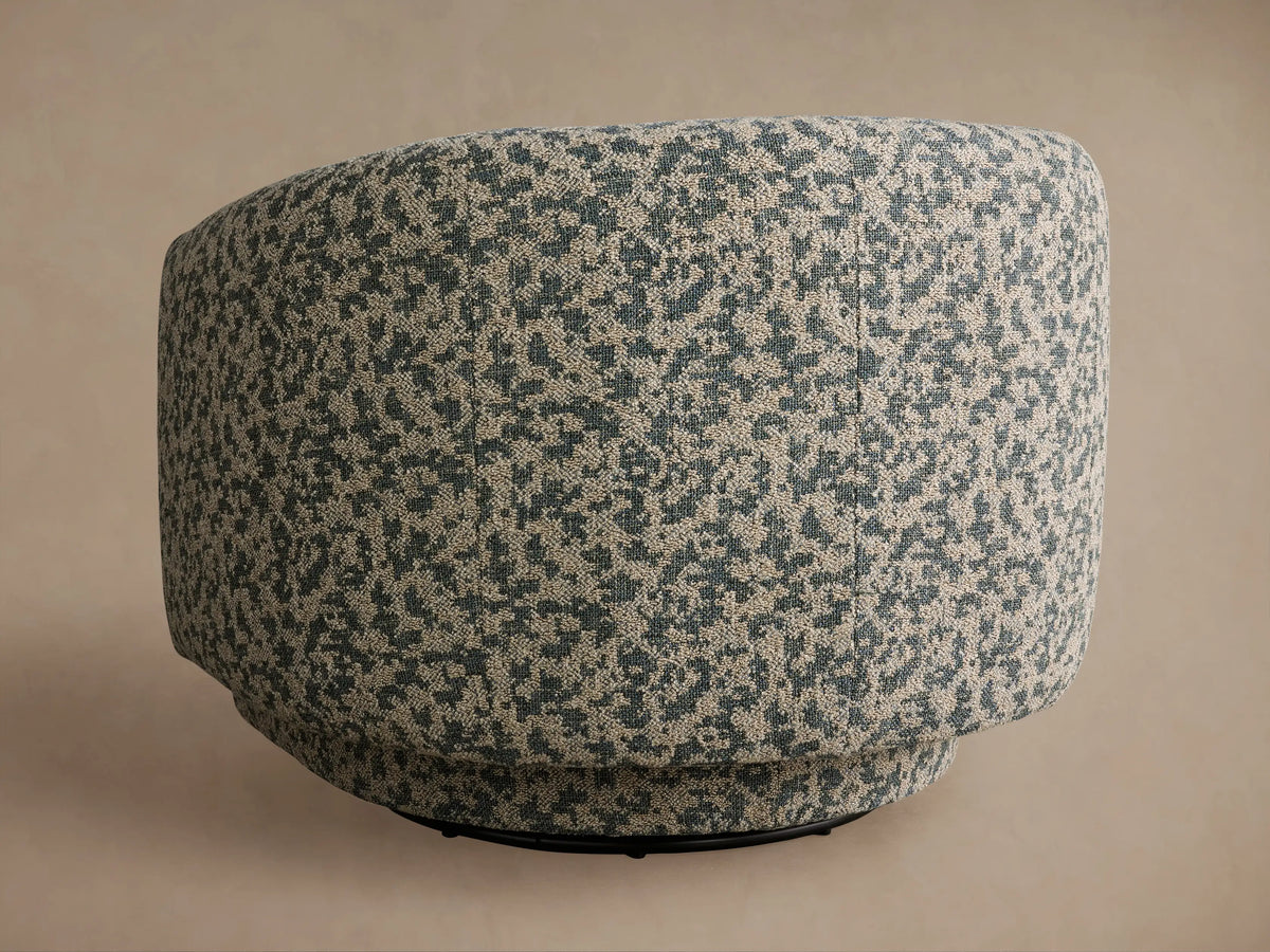 Hamlin Swivel Chair close-up: textured upholstery in mottled beige and muted teal-blue pattern on a curved armrest.