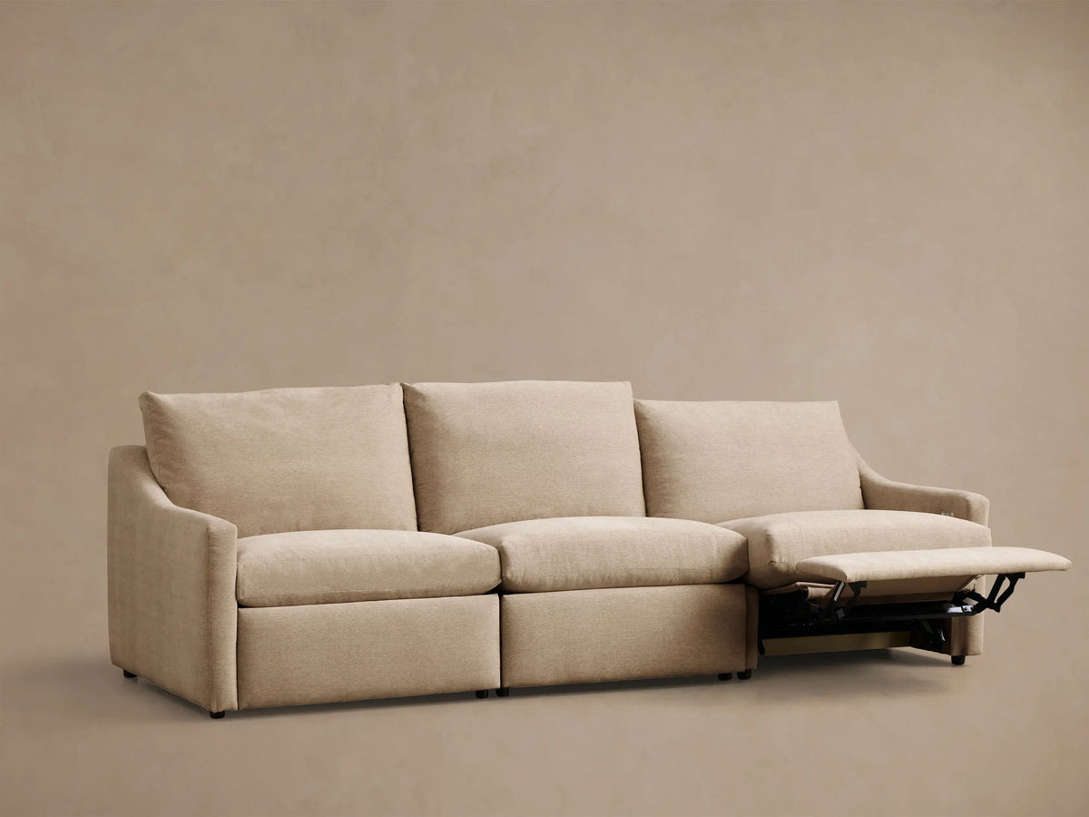 Front view of beige Kipton Slope Arm Three-Piece Motion Modular Sofa with the right-most recliner extended.