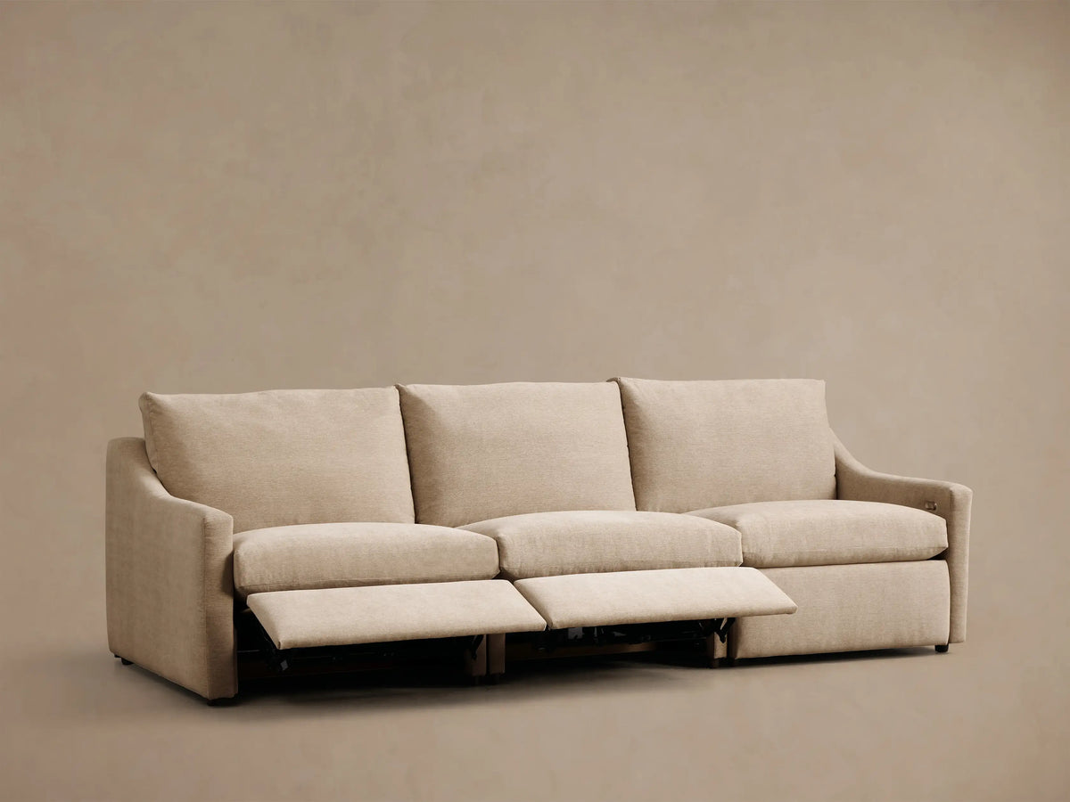 Front view of the beige Kipton Slope Arm Three-Piece Motion Modular Sofa with two footrests extended.