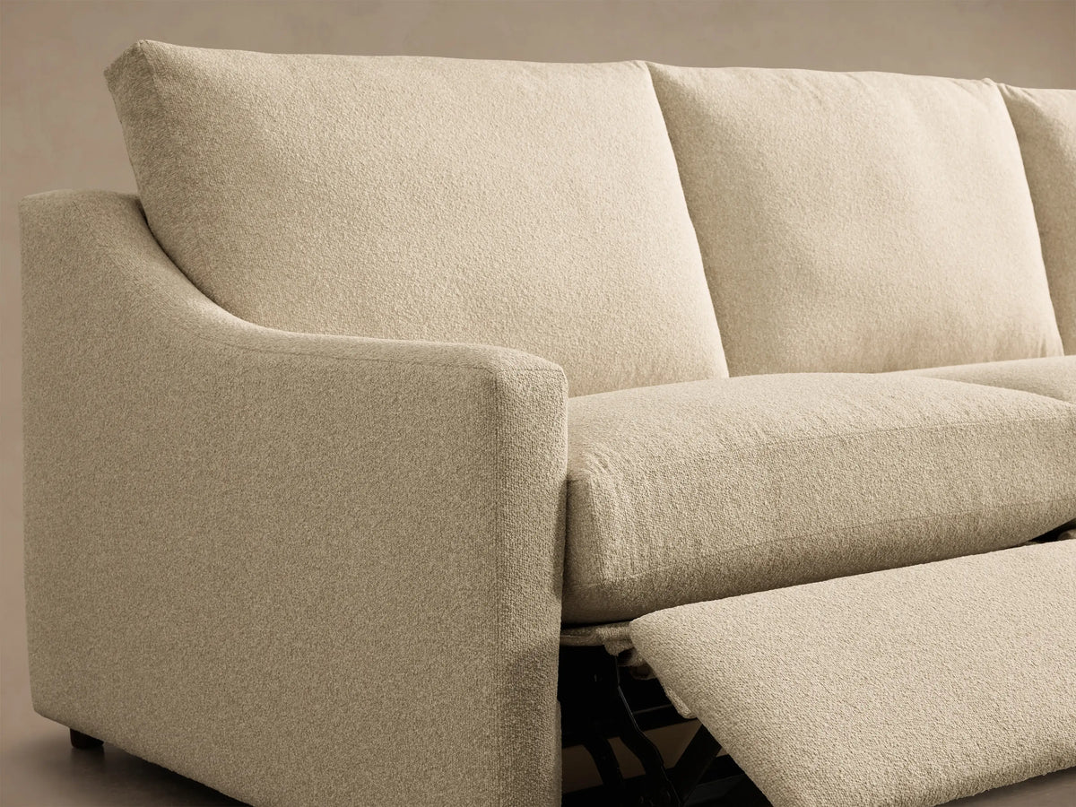 Close-up of the cream Kipton Slope Arm Three-Piece Motion Modular Sofa, showing the sloped arm and extended footrest.