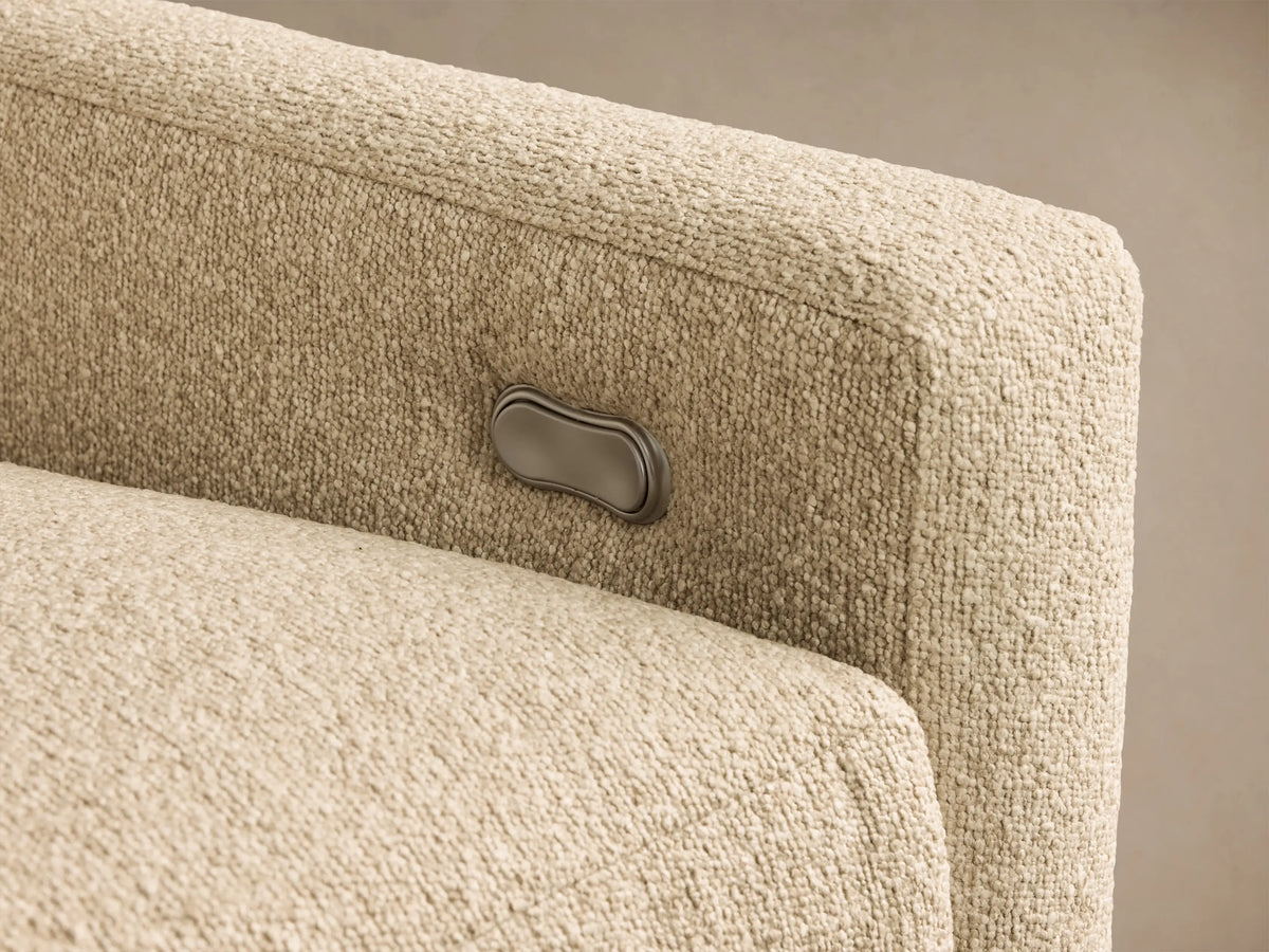 Close-up of light beige textured fabric on the Kipton Slope Arm Three-Piece Motion Modular Sofa, showing a silver recliner control button.