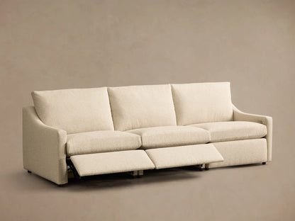 Front view of the cream Kipton Slope Arm Three-Piece Motion Modular Sofa, with two of the three footrests extended.