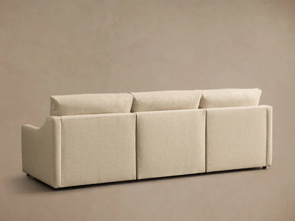 Rear view of the beige Kipton Slope Arm Three-Piece Motion Modular Sofa, showing its three modular sections and textured fabric.