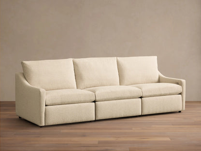 Front view of the cream Kipton Slope Arm Three-Piece Motion Modular Sofa, featuring three modular sections with loose cushions and slope arms.