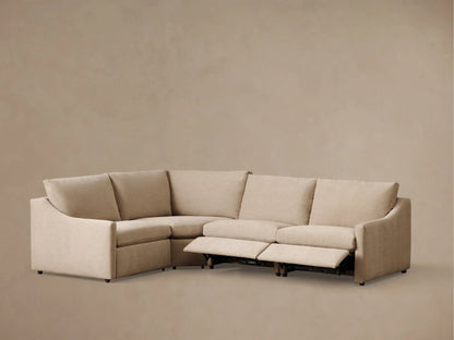 Front view of a light beige Kipton Slope Arm Four-Piece Motion Sectional with one recliner extended.