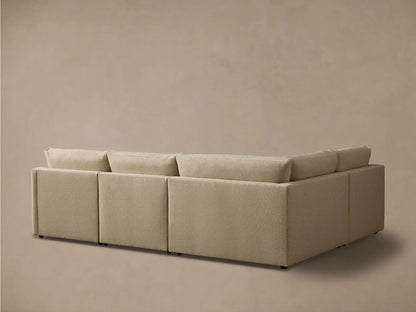 Close-up of a beige Kipton Slope Arm Four-Piece Motion Sectional, showing textured fabric and a partially extended footrest.