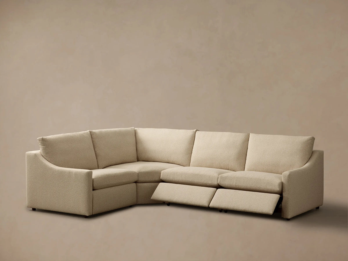 Rear view of the light beige Kipton Slope Arm Four-Piece Motion Sectional, highlighting its textured fabric and modular design.