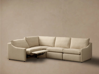Front view of a light beige Kipton Slope Arm Four-Piece Motion Sectional with one extended footrest.