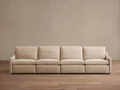 Front view of a beige Kipton Slope Arm Four-Piece Motion Modular Sofa with four seat cushions and sloped arms.
