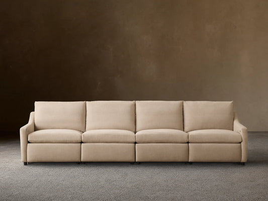 Front view of a beige Kipton Slope Arm Four-Piece Motion Modular Sofa with four seat cushions and sloped arms.