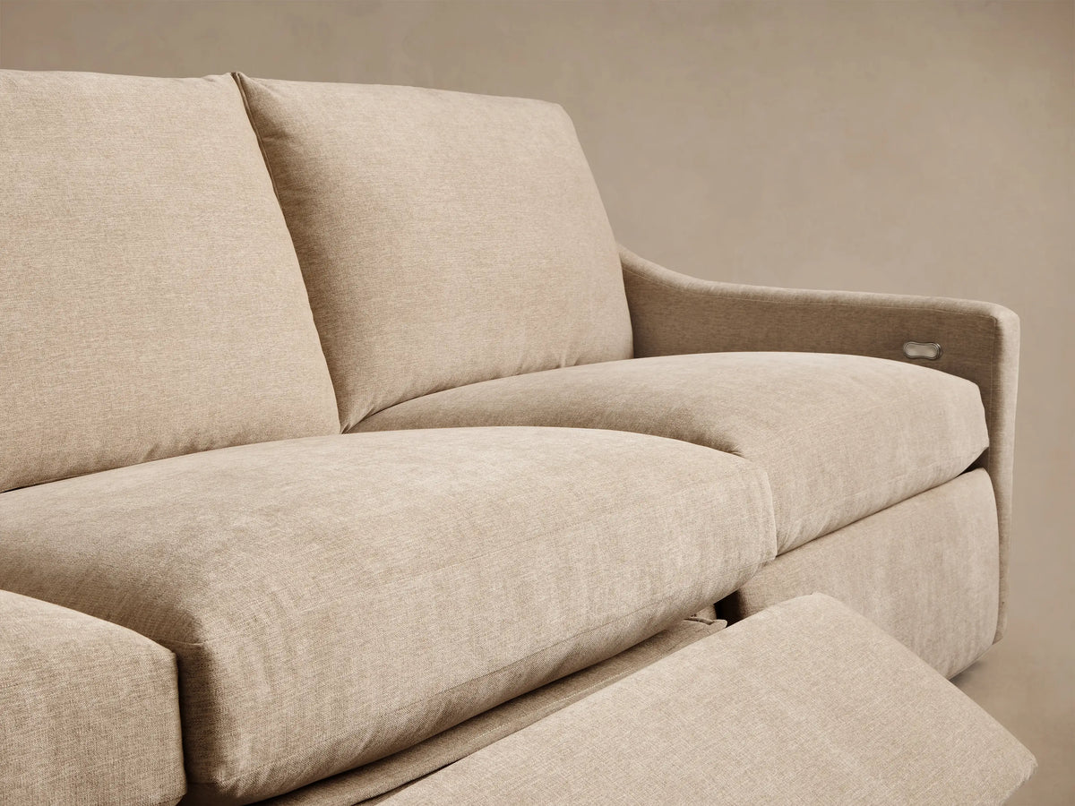 Close-up of the beige woven fabric on the Kipton Slope Arm Four-Piece Motion Modular Sofa™ with a silver motion control panel.