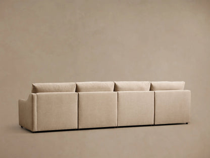 Close-up of a beige Kipton Slope Arm Four-Piece Motion Modular Sofa, showing a slope arm with a motion control button, modular sections, and an extended footrest.