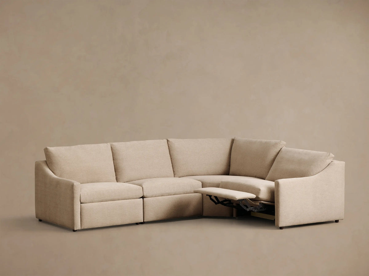 Front view of the beige Kipton Slope Arm Four-Piece Motion Sectional, an L-shaped sofa with two reclining sections and sloped arms.