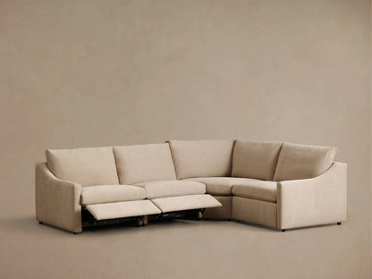 Front view of the light beige Kipton Slope Arm Four-Piece Motion Sectional with one reclining footrest extended.