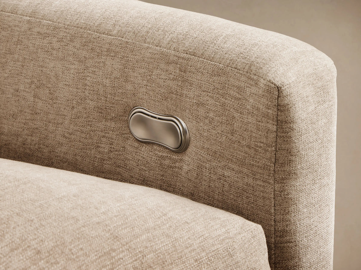 Close-up of the light beige Kipton Slope Arm Four-Piece Motion Sectional with a reclined seat, elevated footrest, and arm controls.