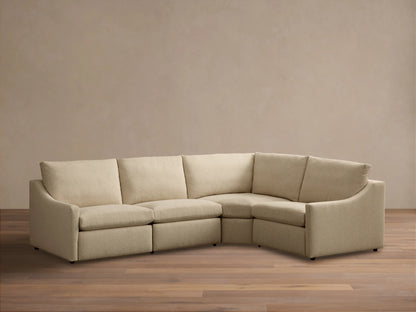 Front view of the beige Kipton Slope Arm Four-Piece Motion Sectional, an L-shaped sofa with sloped arms.